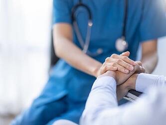 nurse holding hand of a patient
